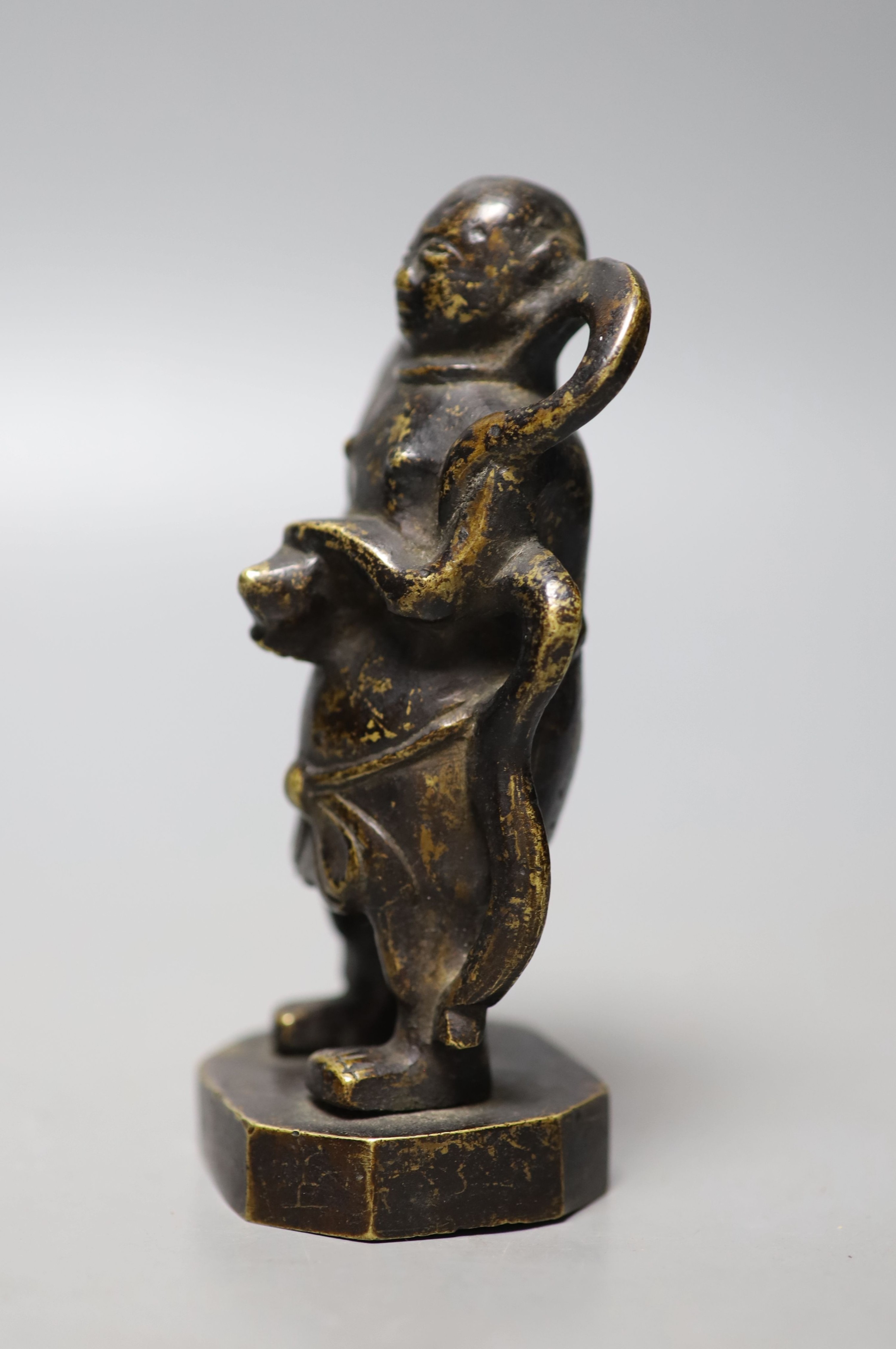 A 19th century Chinese bronze figure of a boy, 12cm